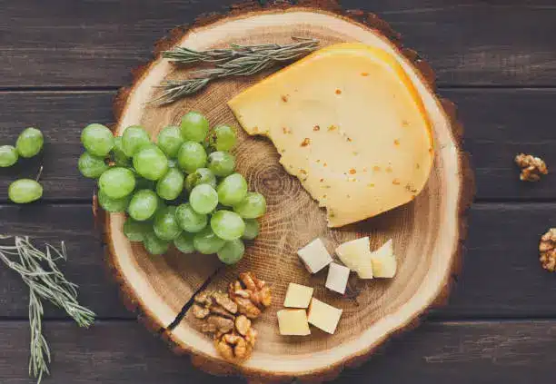 A cheese platter featuring Gouda cheese, paired with nuts and fruits, showcasing its versatility.