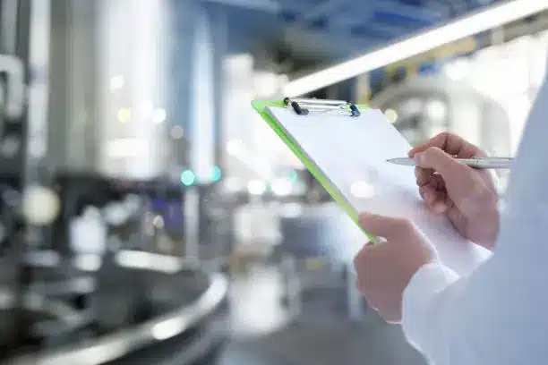 A quality control inspector checking food products in a factory - food manufacturing industry