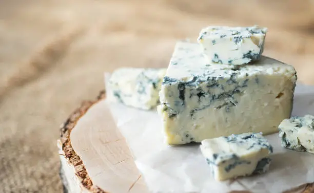 blue cheese with visible blue veins, showcasing its unique appearance.